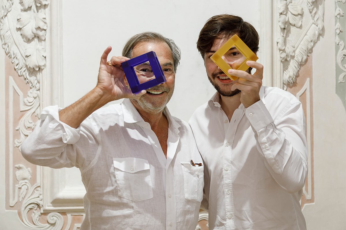 two men holding artworks