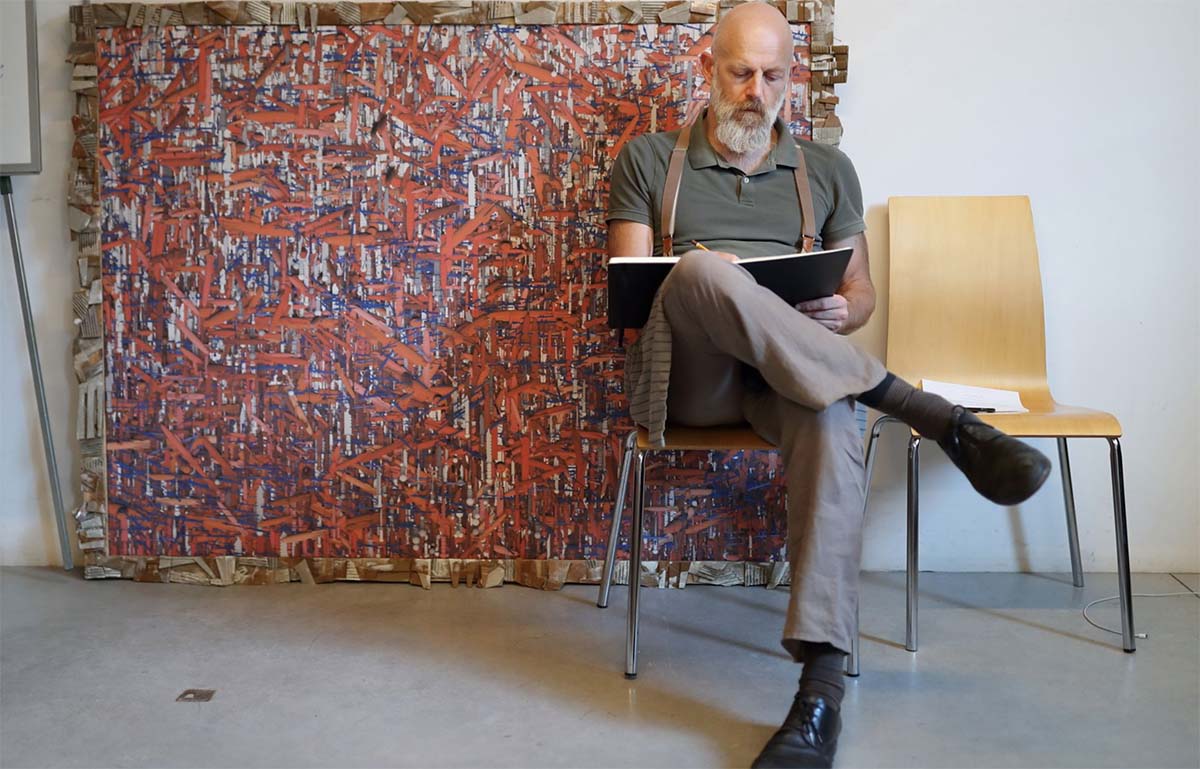 artist drawing in front of canvas
