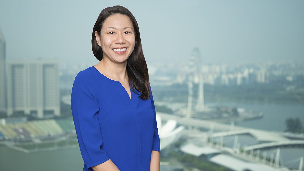 Eugenia Koh wearing a blue dress