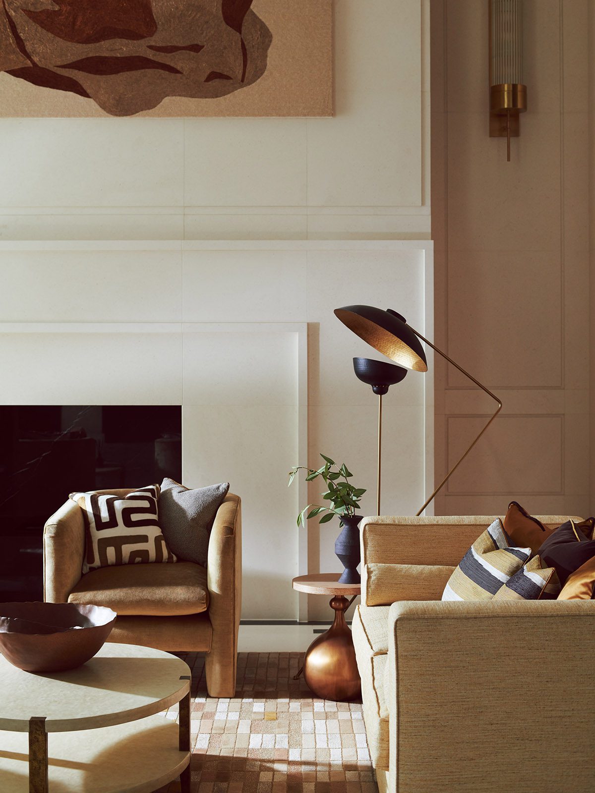 A living room with fireplace and armchairs