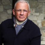 Pascal Raffy wearing a watch and blue jacket with a blue scarf and turtle neck