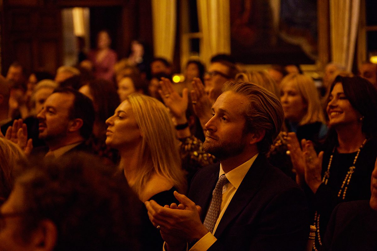 A man clapping in an audience