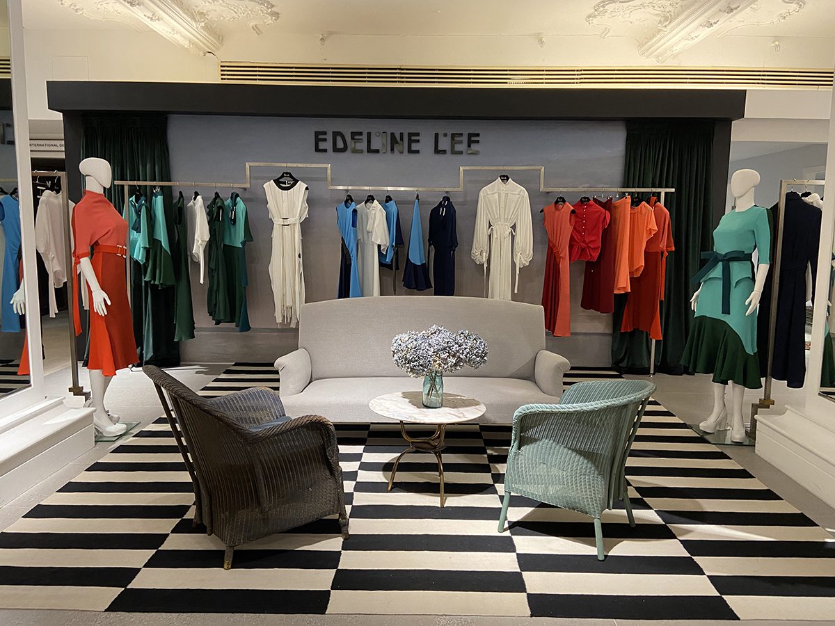 a clothing stand with chairs and a table
