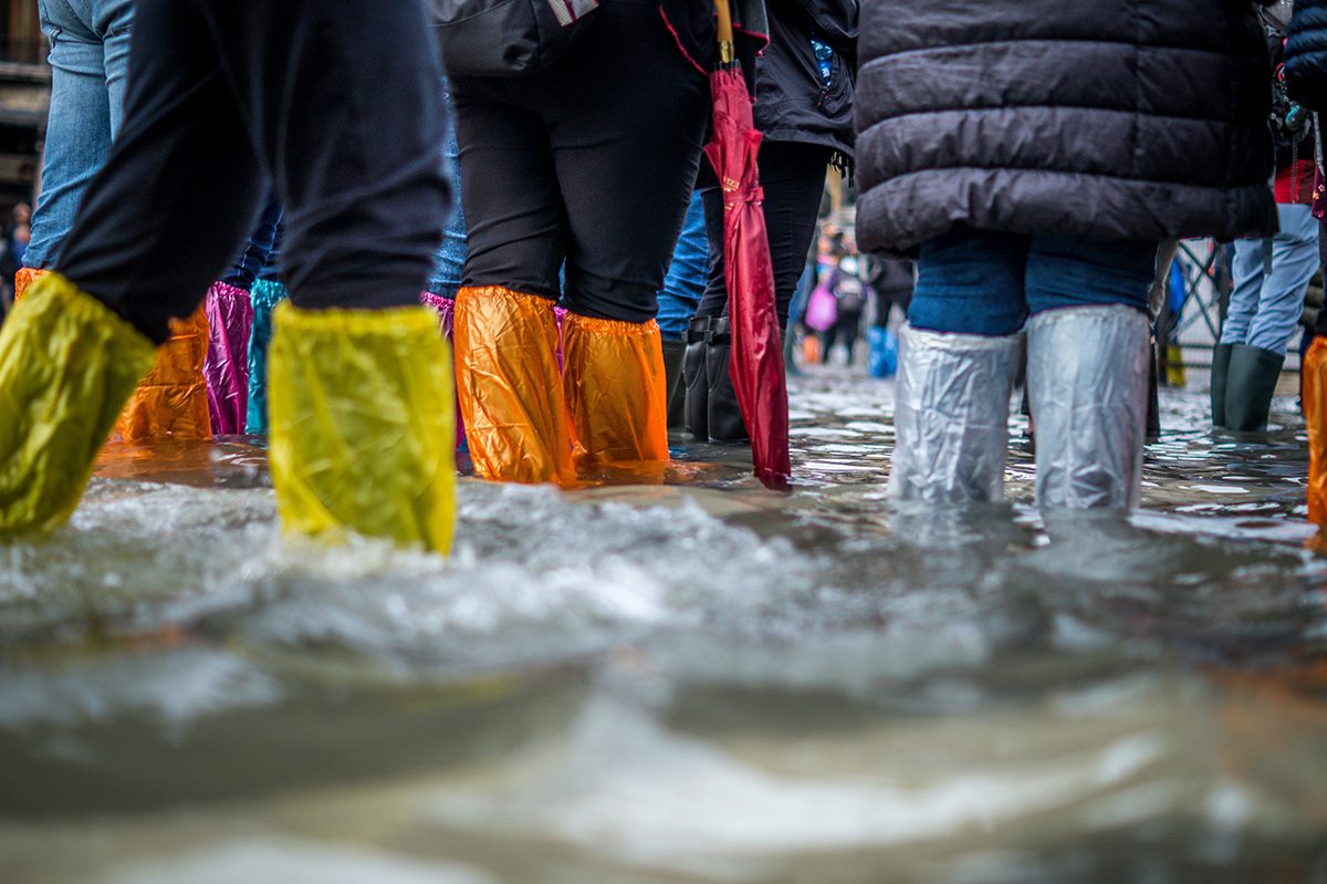 people walking through a flood