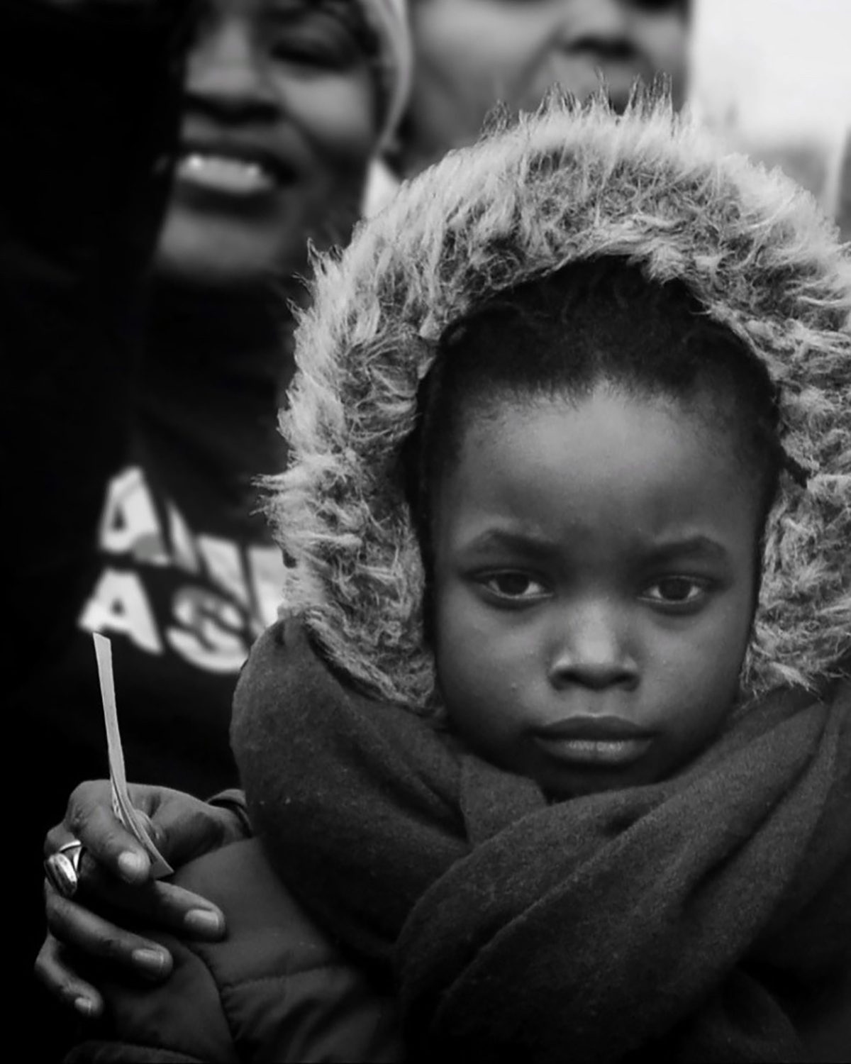 A child wearing a fury hood and scarf