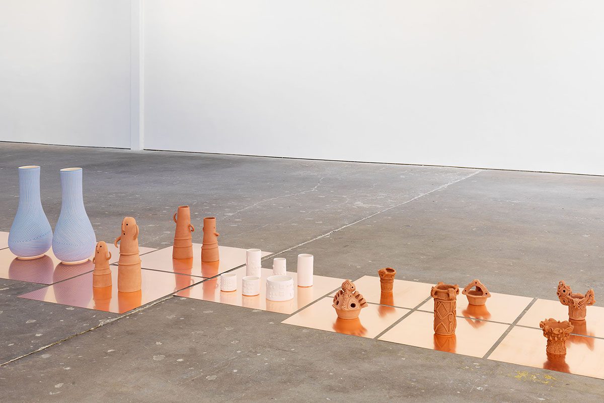 blue vases and orange trinkets on the floor