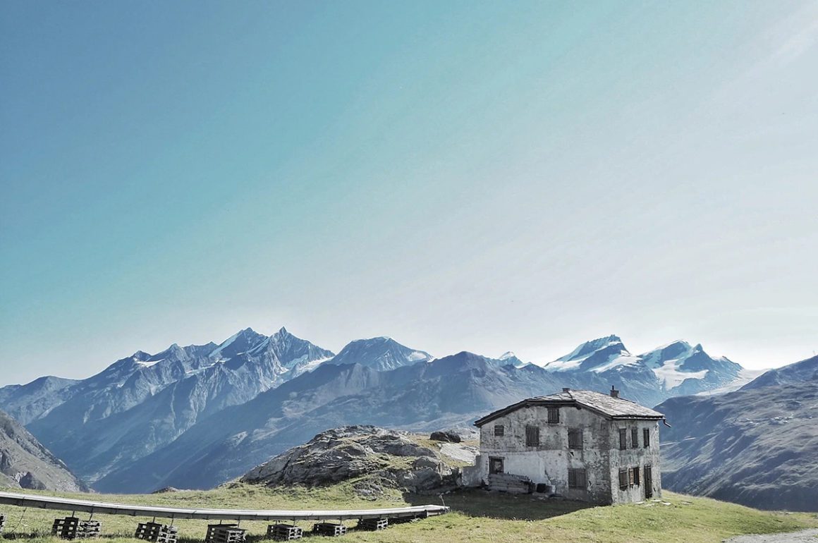 mountains and an alpine lodge on the grass