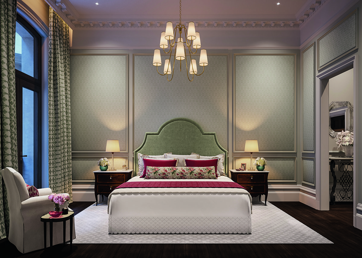 A bedroom with a green headboard, red cushions and throw on the bed