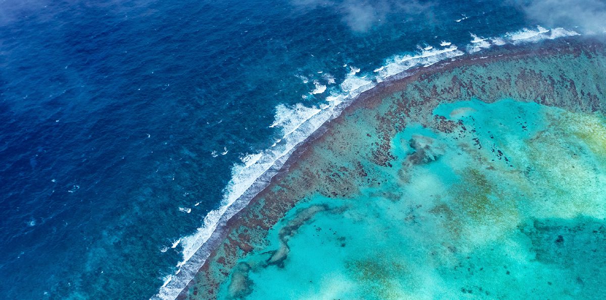 turquoise sea and the deep sea with waves next to it
