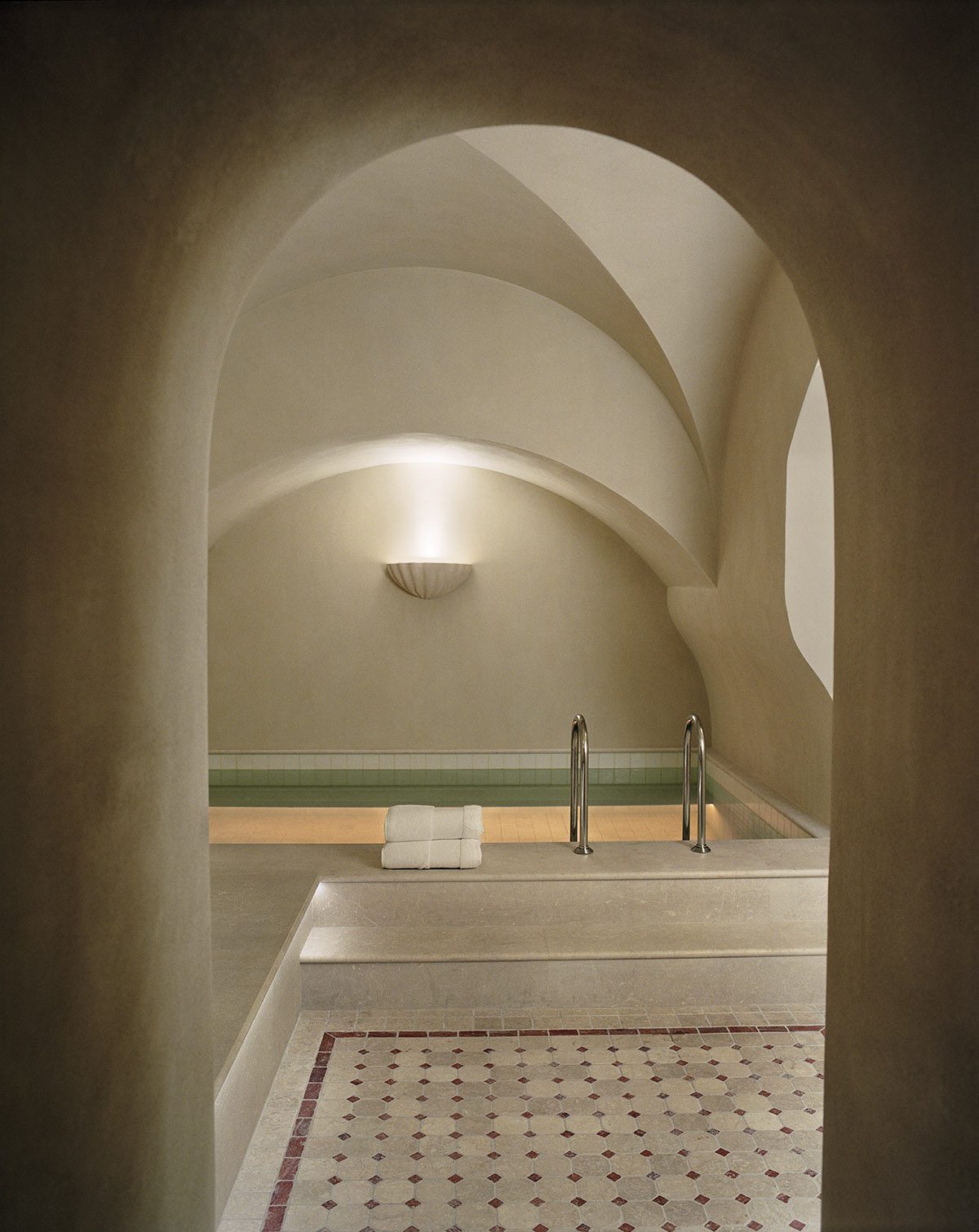 An arch leading to a pool in a spa