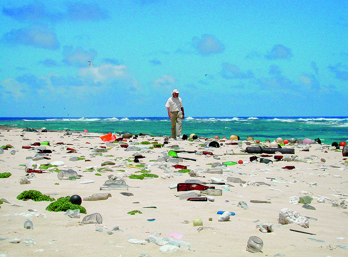man on beach with plastic