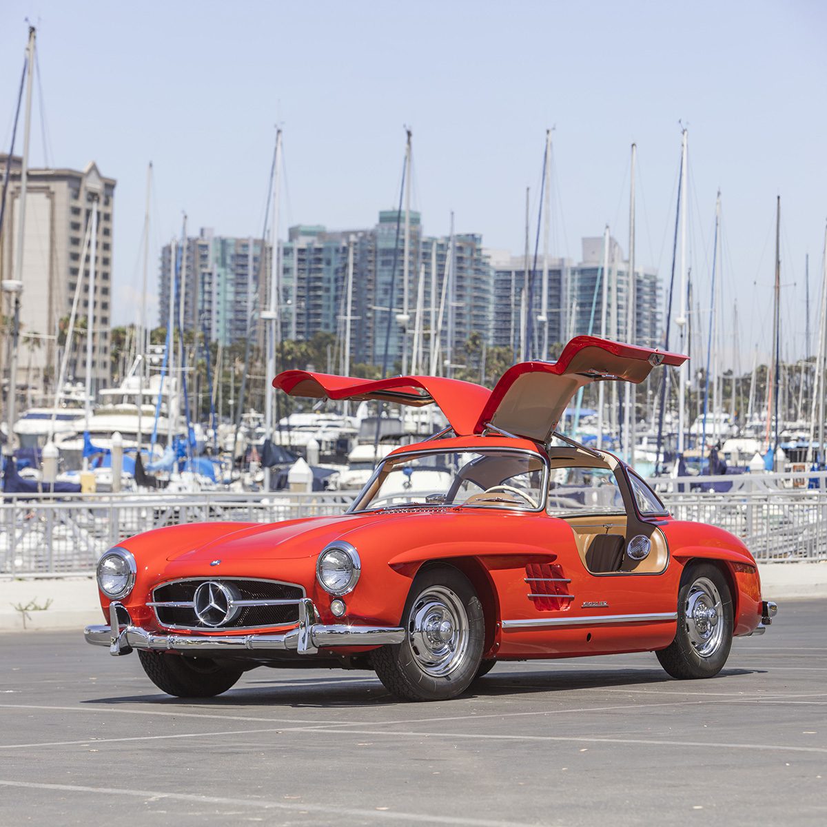 a red car with the doors opening over the roof