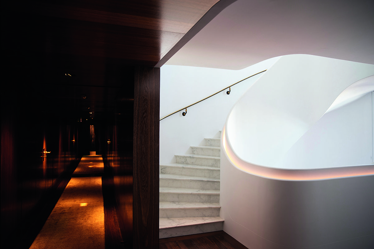 A hallway and white marble staircase
