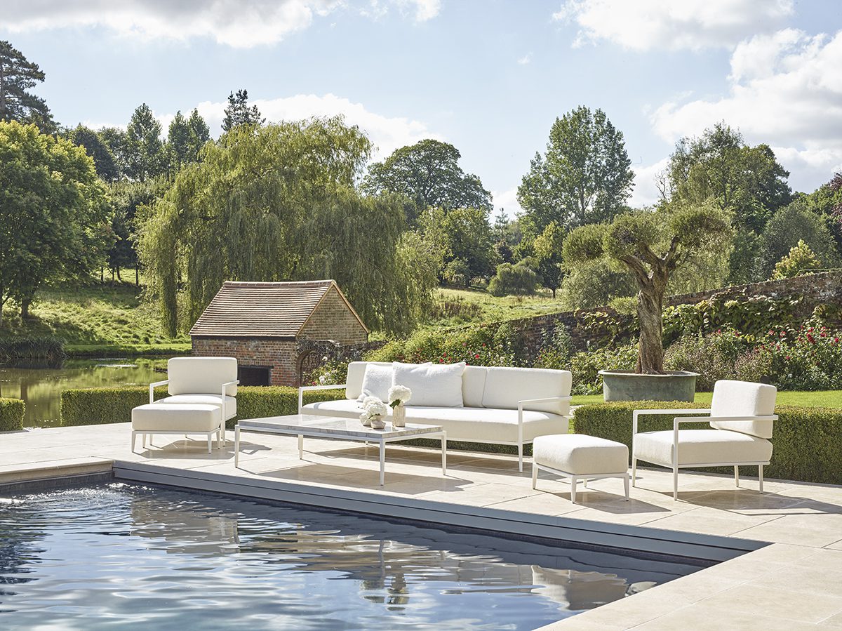 HyperFocal: 0 white tables and chairs in front of a swimming pool with a hut in the background