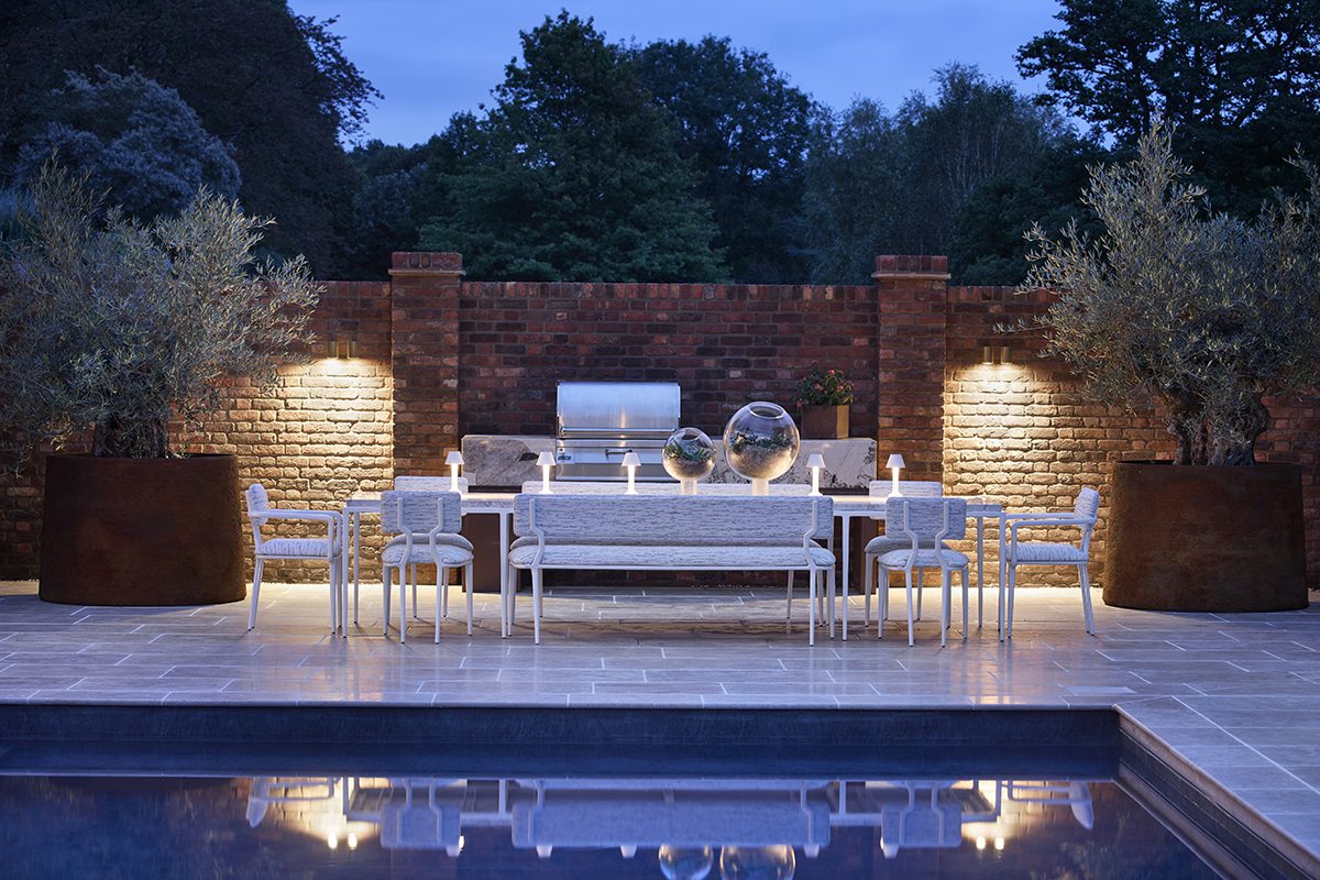 FBC London Outdoor Collection (4) white tables and chairs in front of a swimming pool