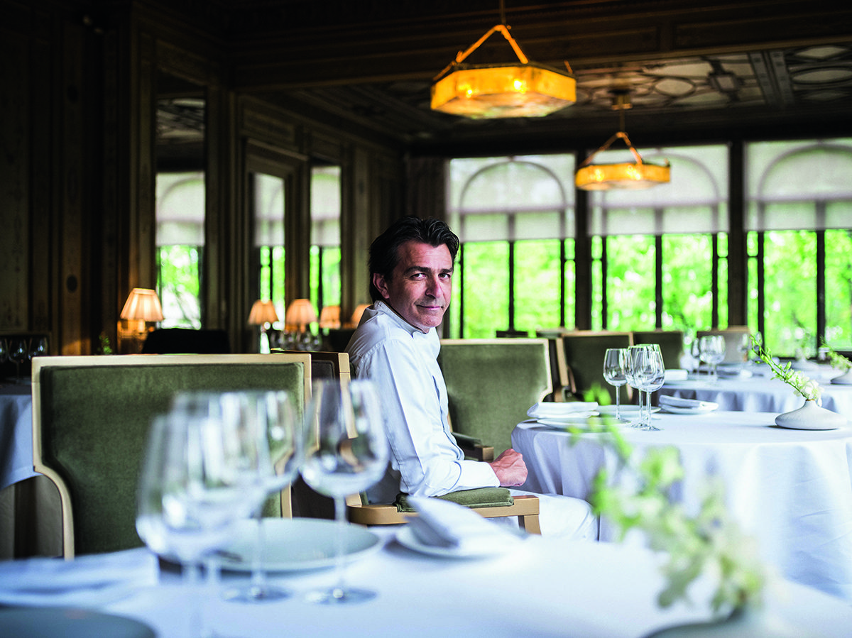 a chef sitting at s table in a restaurant