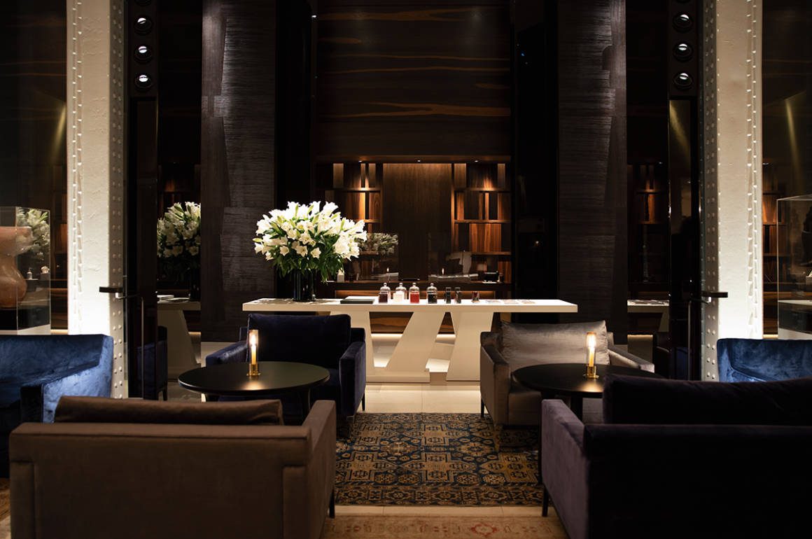 dark bar with black chairs and white flowers