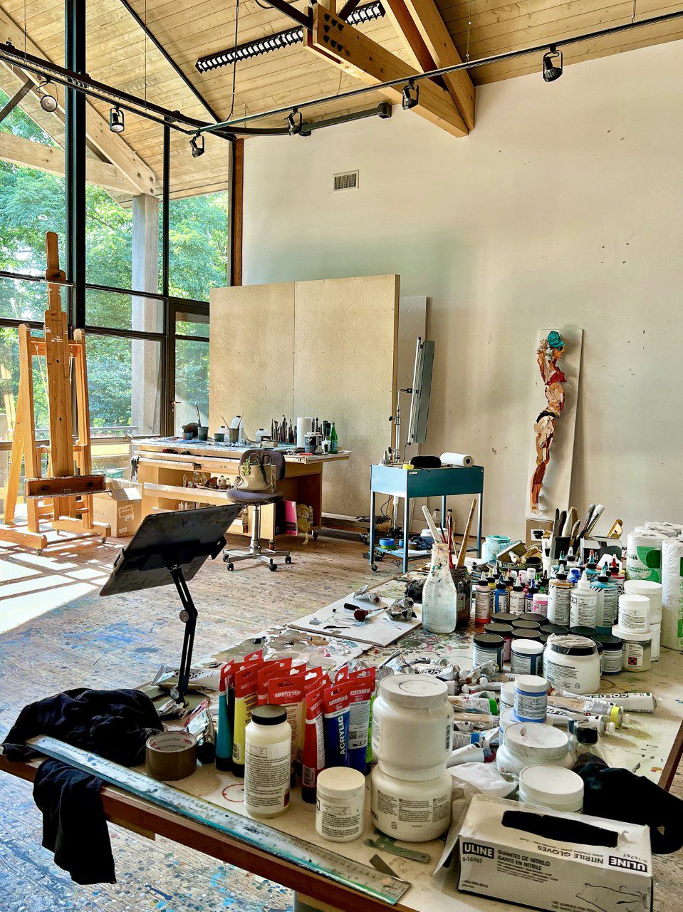 A painting studio with paints and canvases