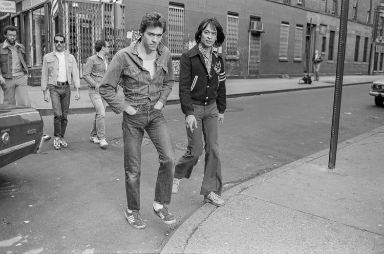 Two men walking onto a pavement 