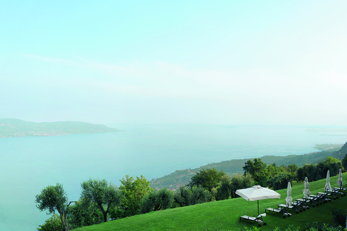 deckchairs on the grass with a view of the lake and mountains