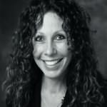 A woman with curly brown hair 