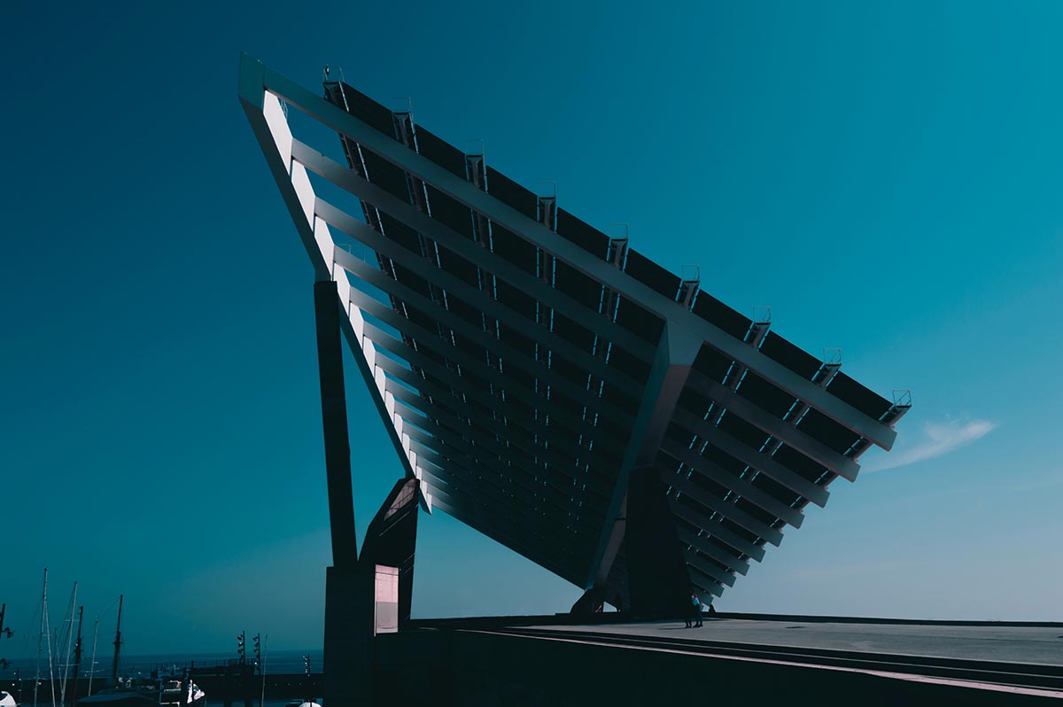 A solar panel below blue sky