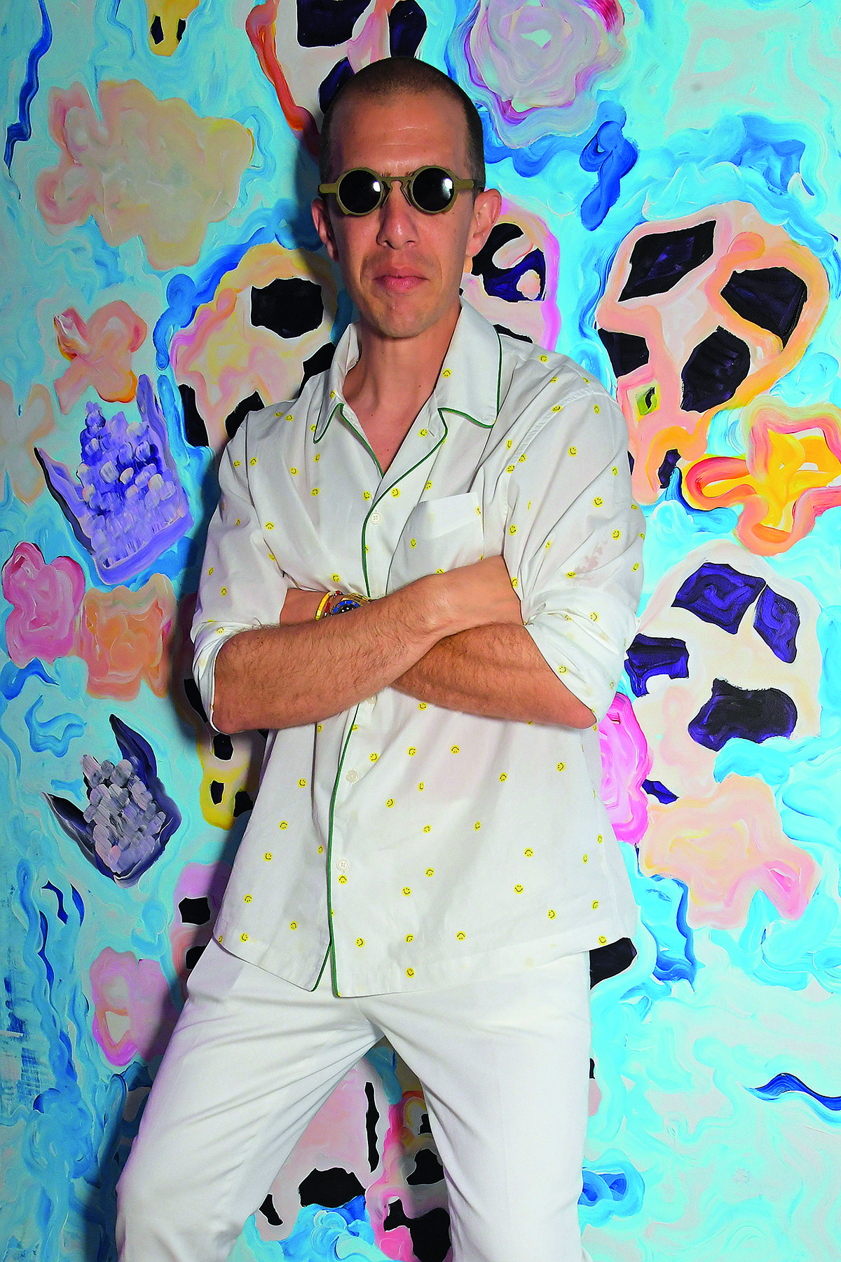 man with sunglasses against a painting 