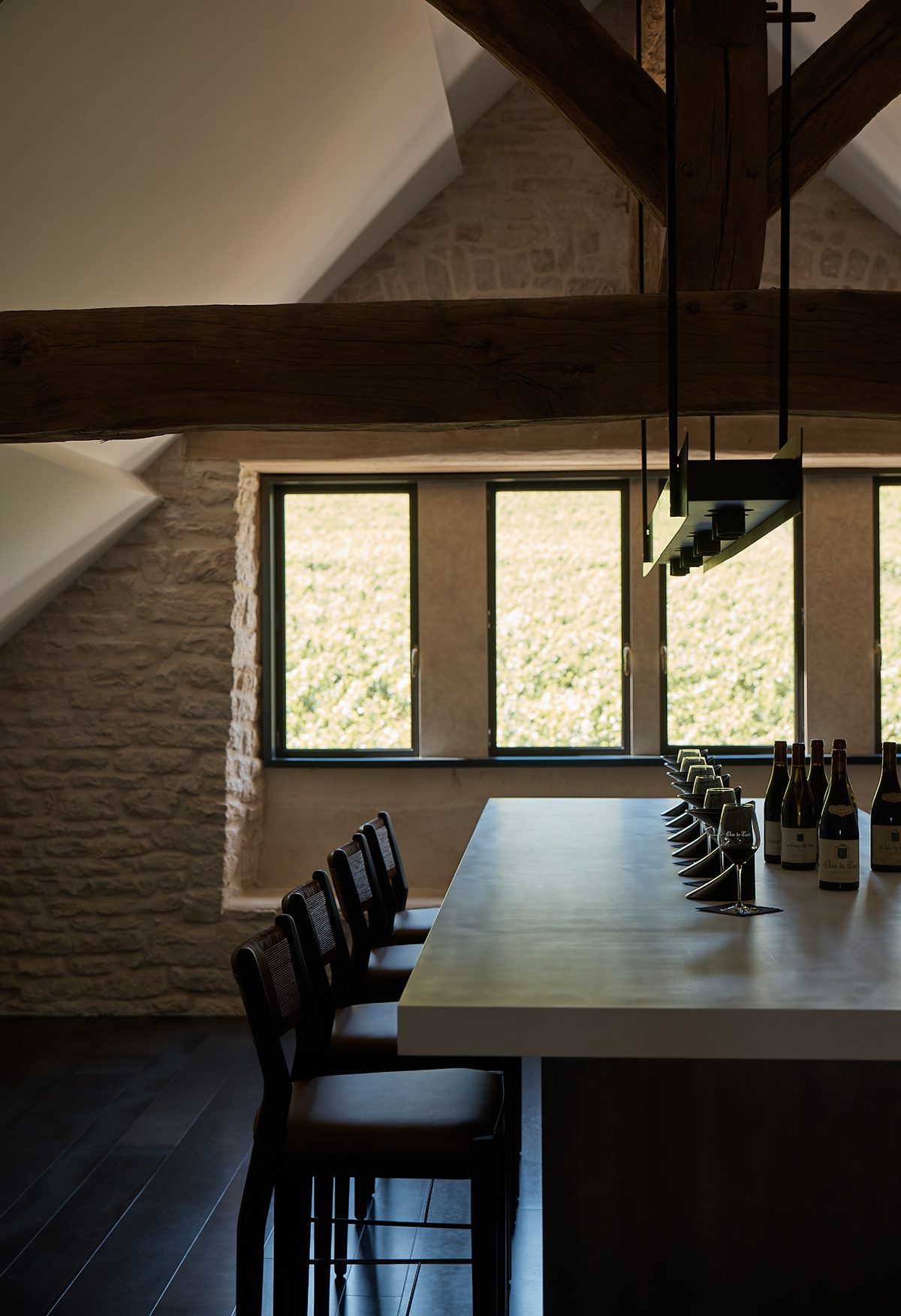 table with windows, chairs, wine glasses 