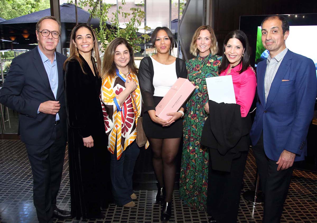 A group photo of women and two men on either side of the group