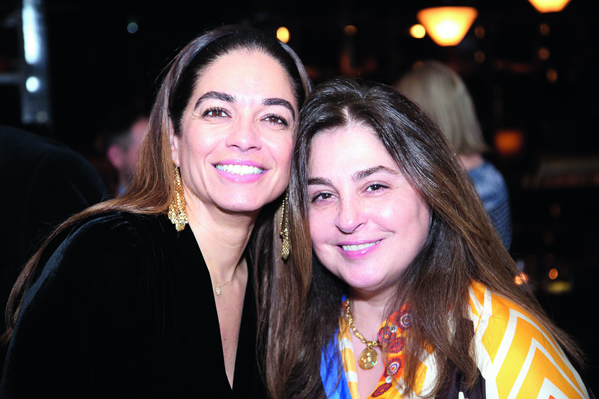 Two women looking at a camera smiling