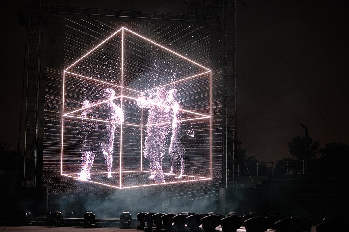 A cube with holograms of people in it 
