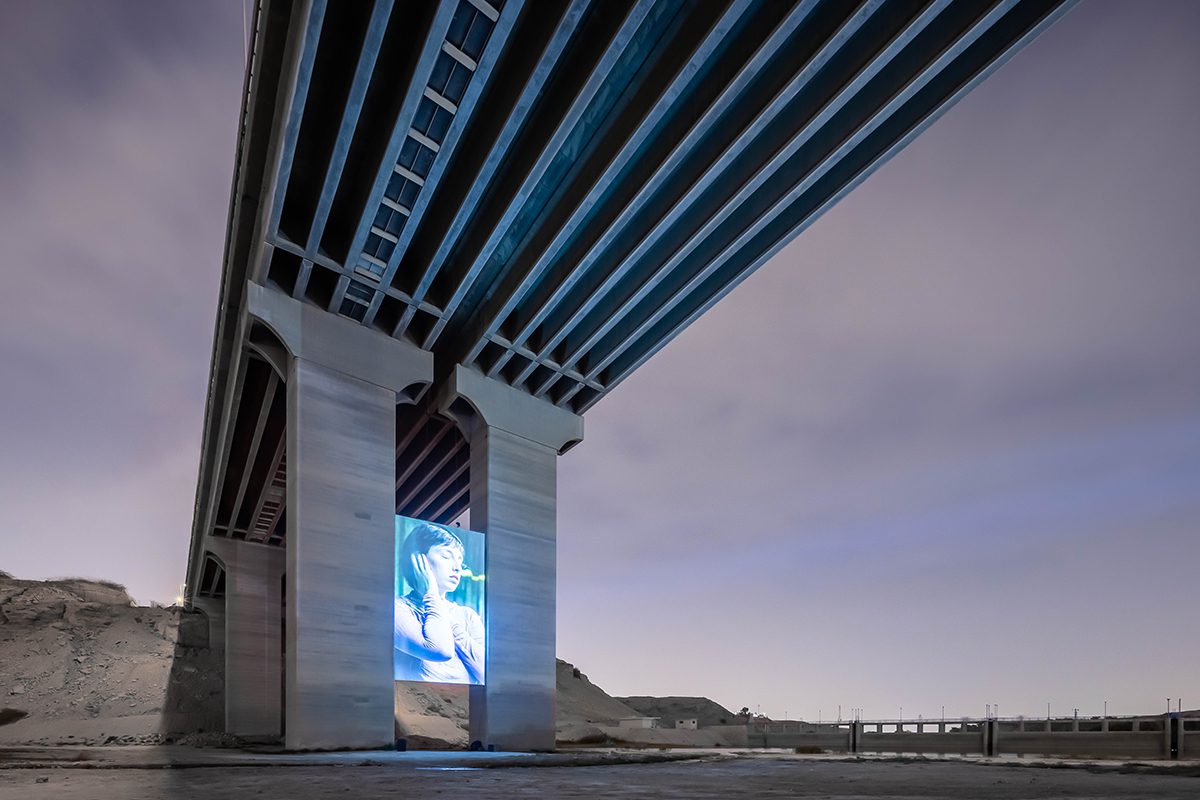 A screen underneath a bridge