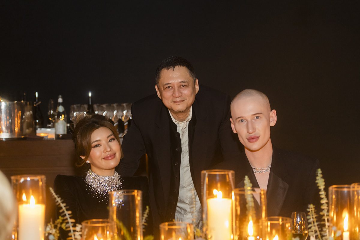 two men and a woman at a dinner