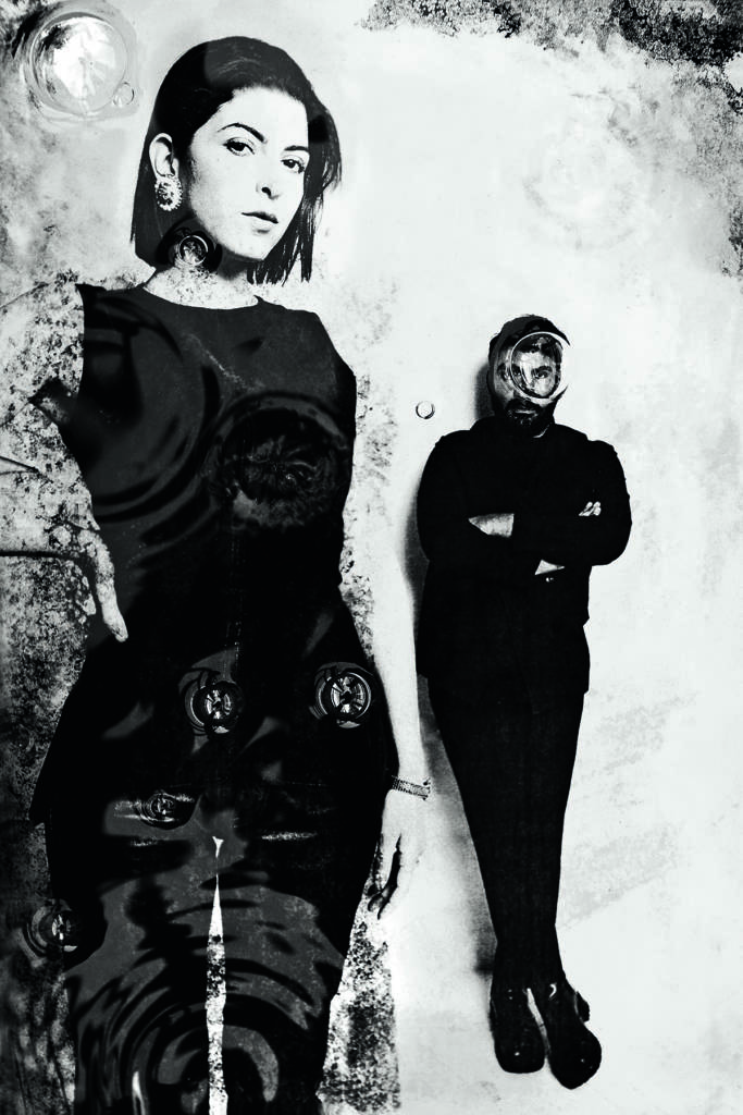A man and woman standing up wearing black