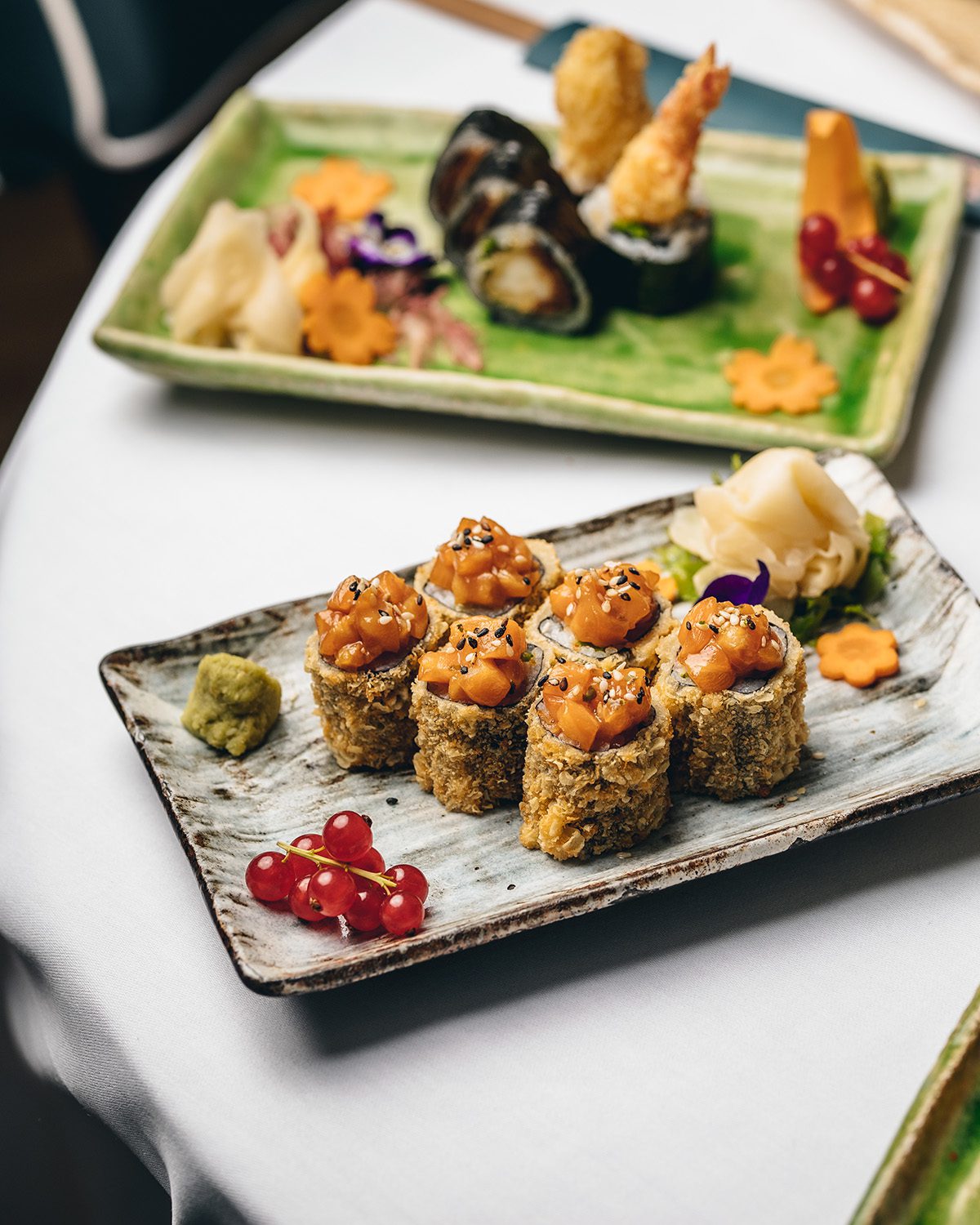 sushi rolls with orange sauce on top