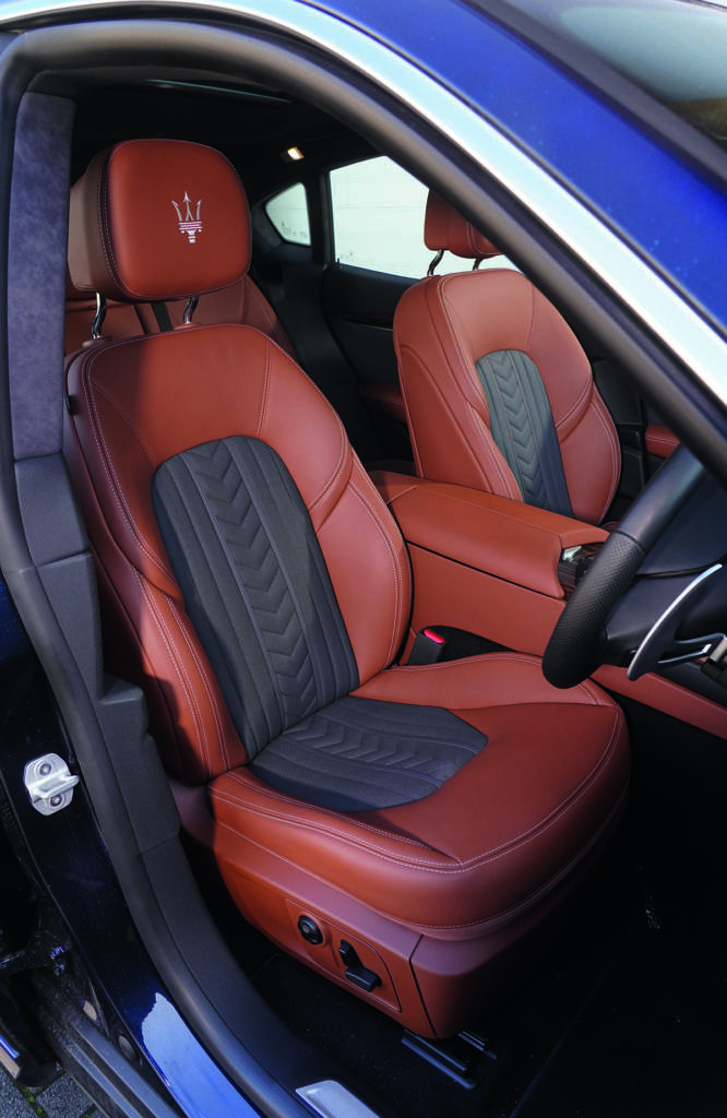 brown and leather and black car seats and a steering wheel