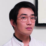A man wearing glasses and a white shirt