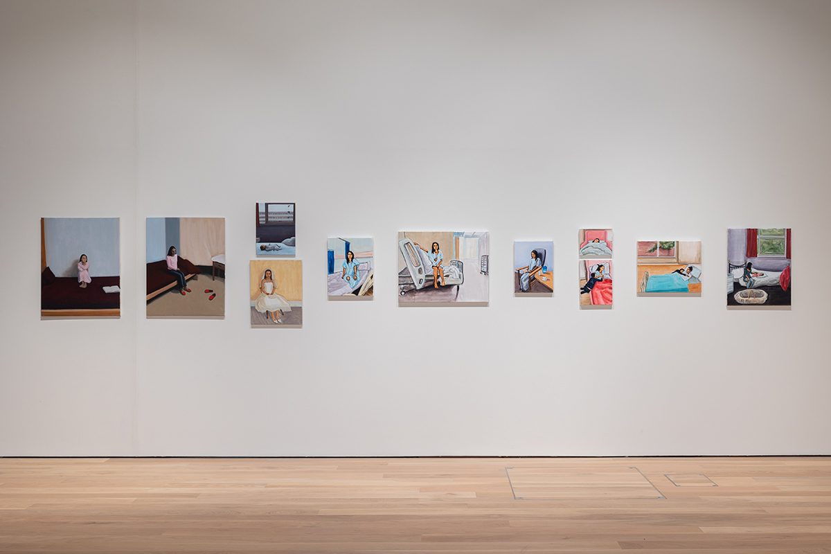 paintings on a wall of a gallery