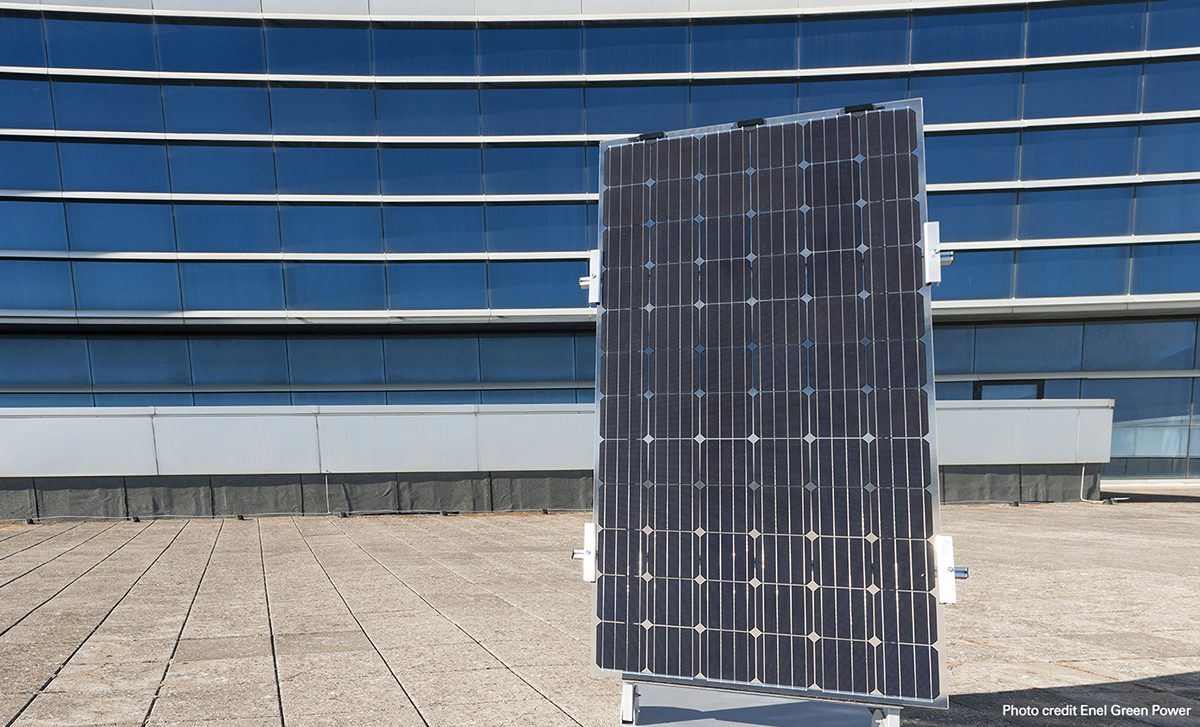 A solar panel in front of a blue board