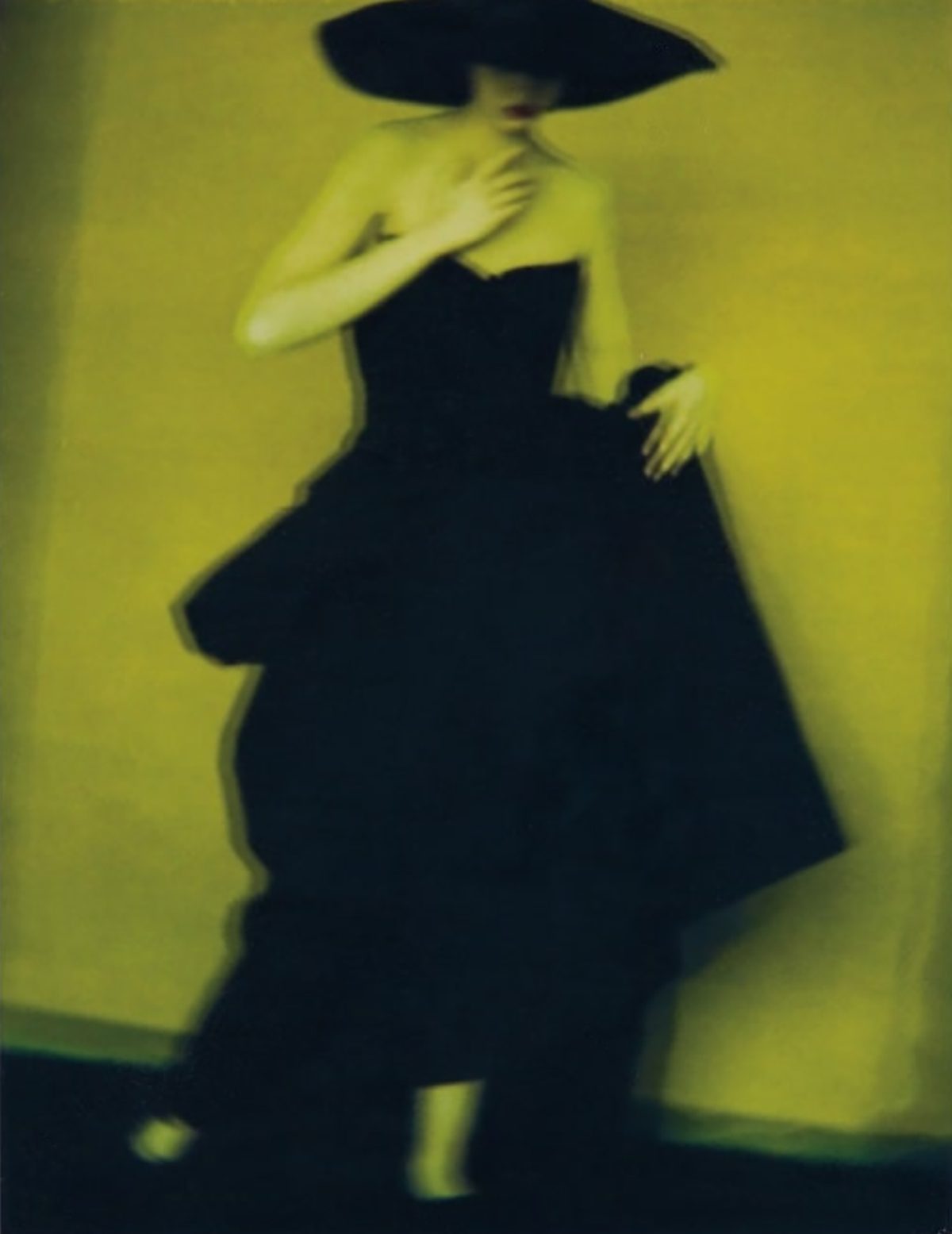 Green photo of a woman wearing a black dress