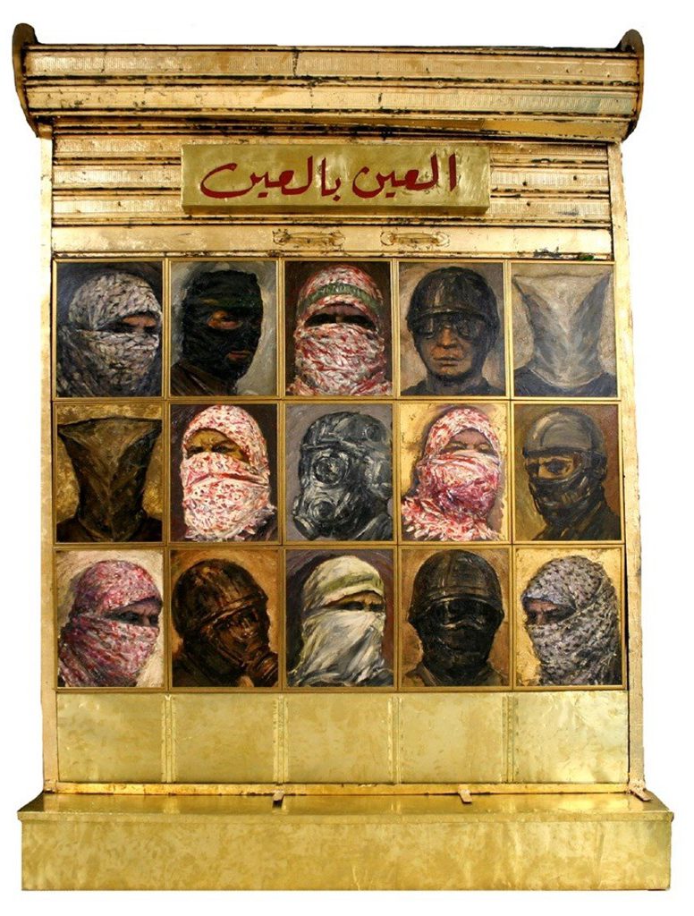 gold pillar with faces on it