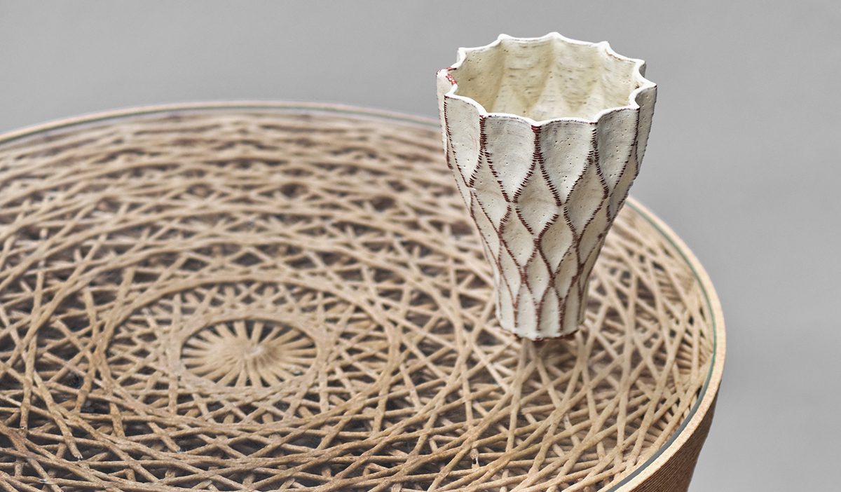 A white cup on a straw mat