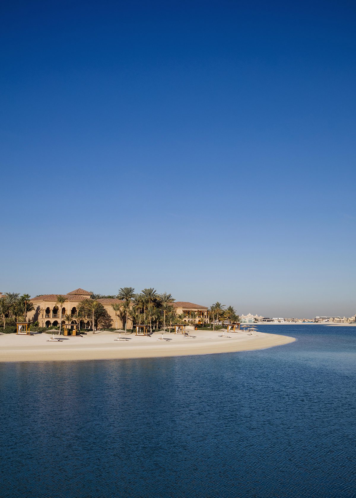 A sand island in the sea with a hotel resort on it