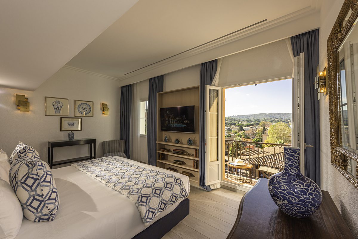 A blue and white bedroom with views of the hills in St Tropez