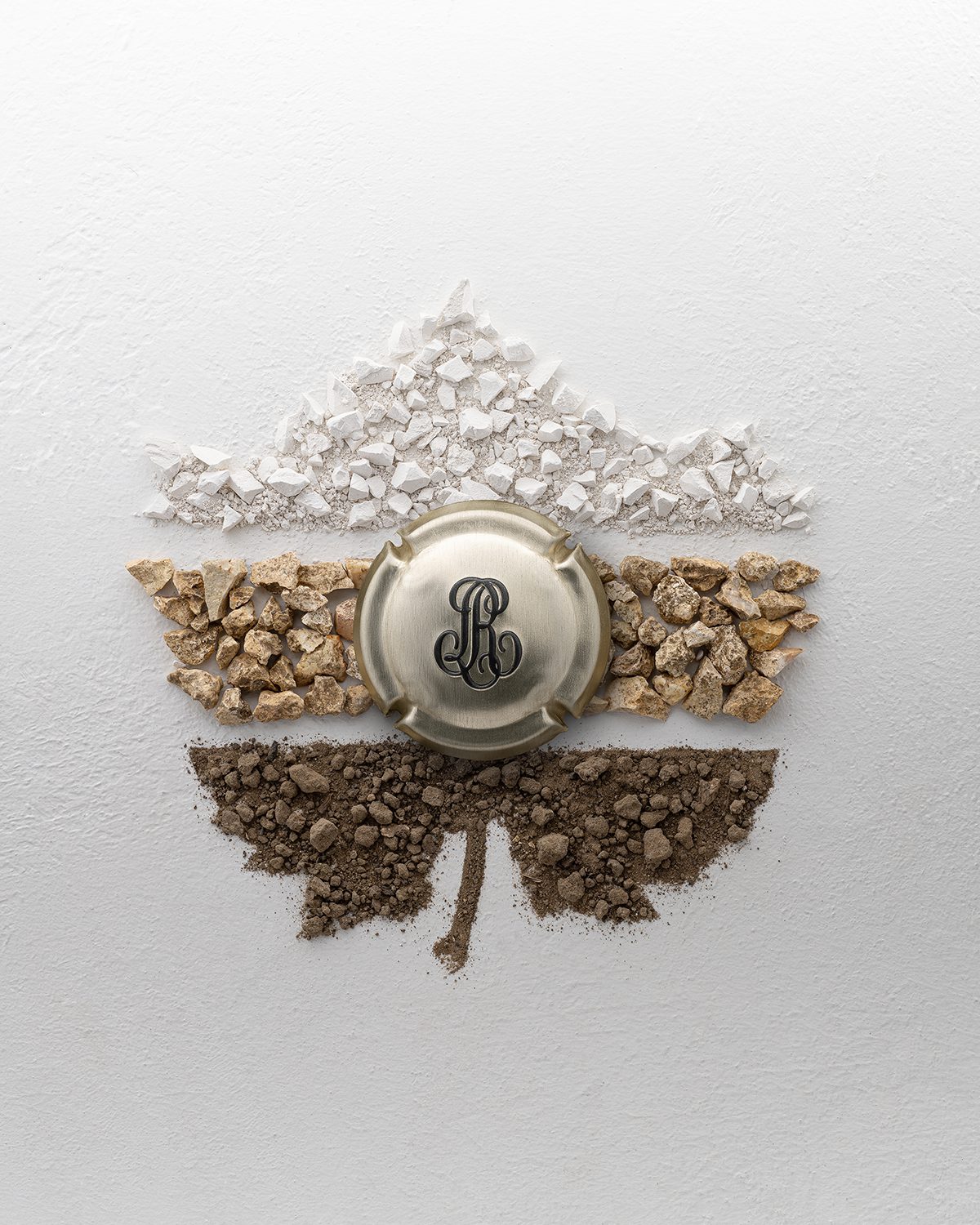 chalk and soil in the shape of a leaf with the Louis Roederer logo in the middle