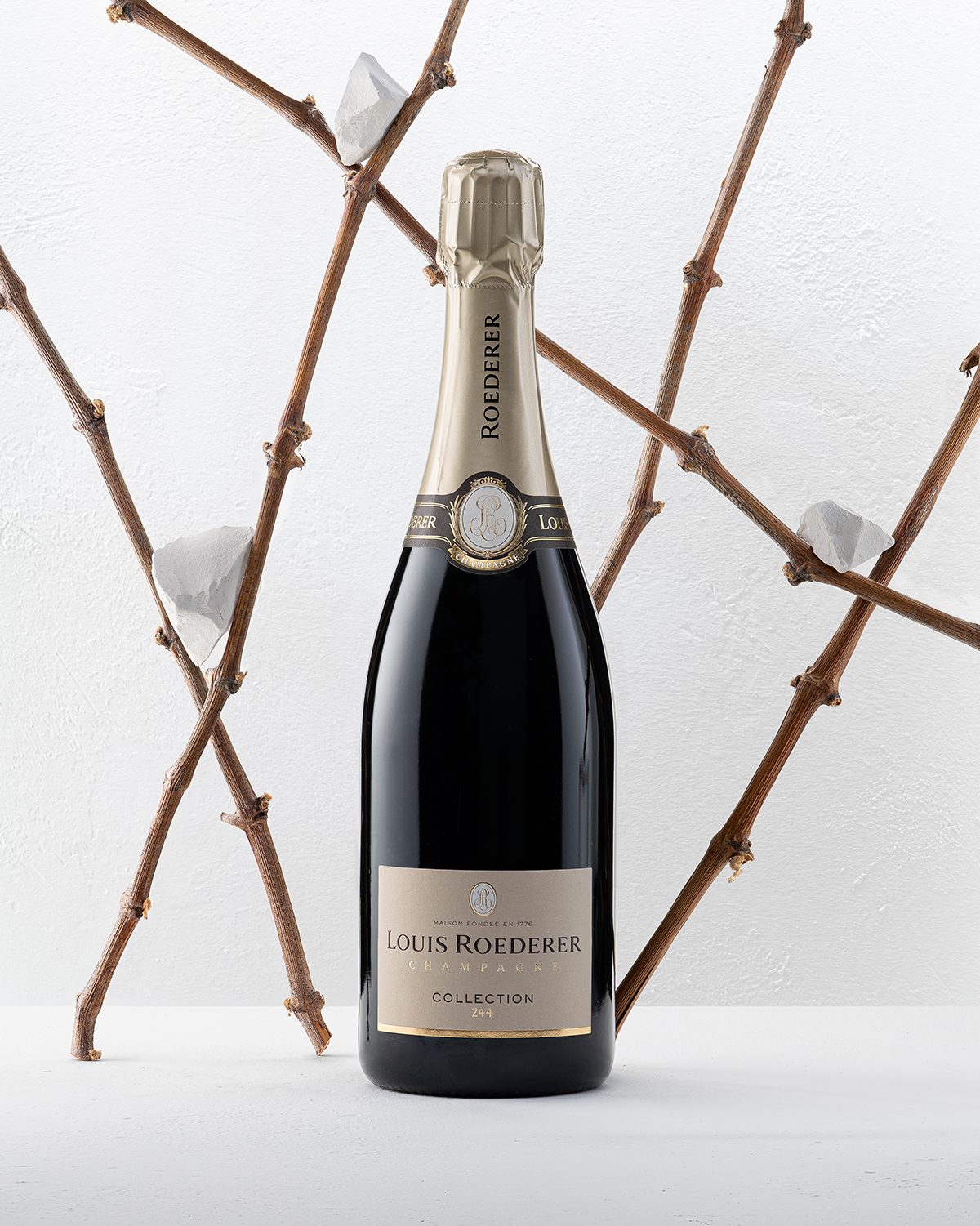 branches stood up around a bottle of champagne
