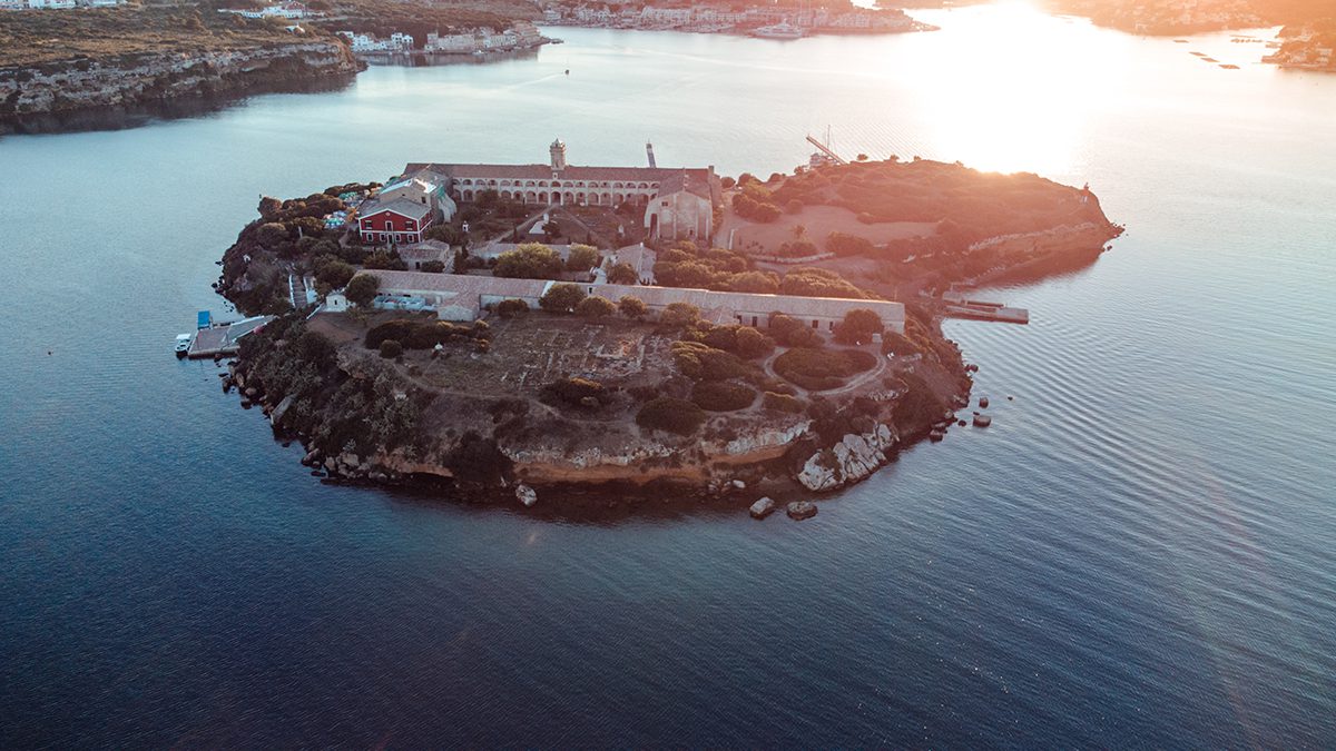 An island in the sea with a house built on it