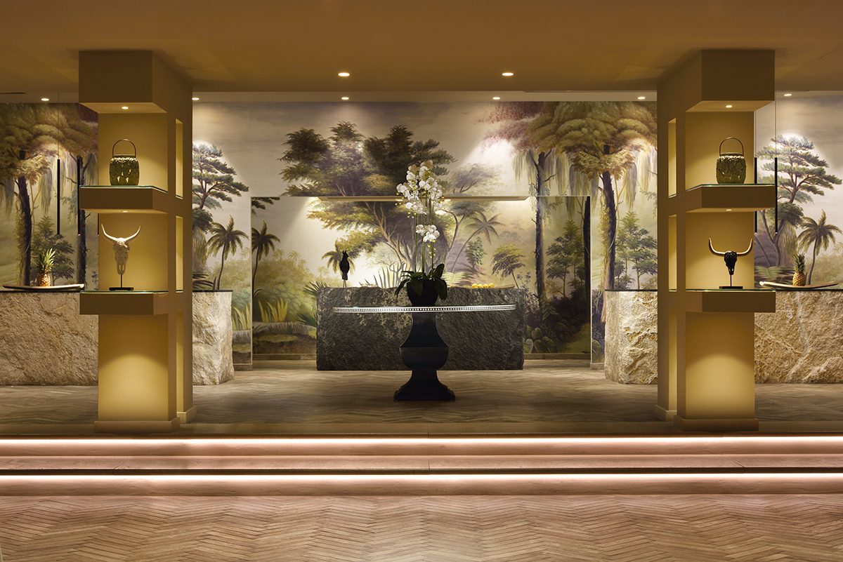 A room with a stage and a large vase in the centre of a table