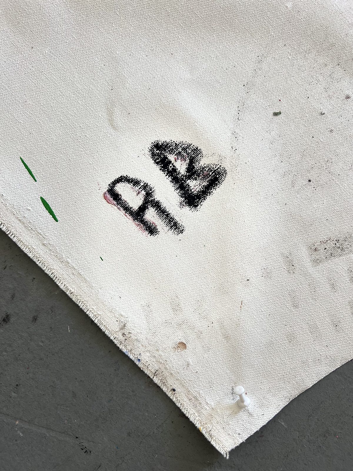 "RB" painted in black on a white canvas