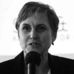 A woman holding a microphone doing a presentation